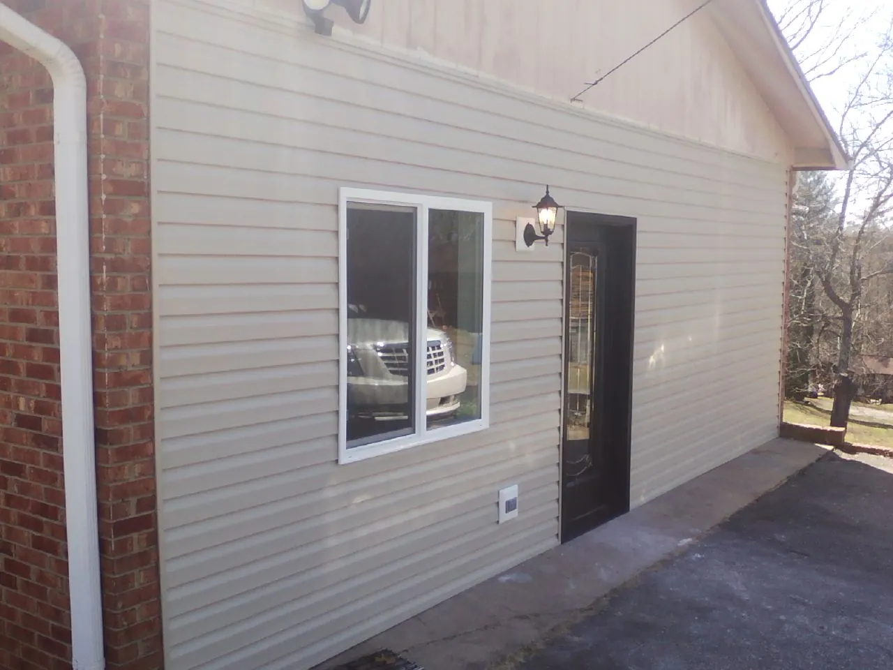 New vinyl siding and entry door on a room addition in Lincoln